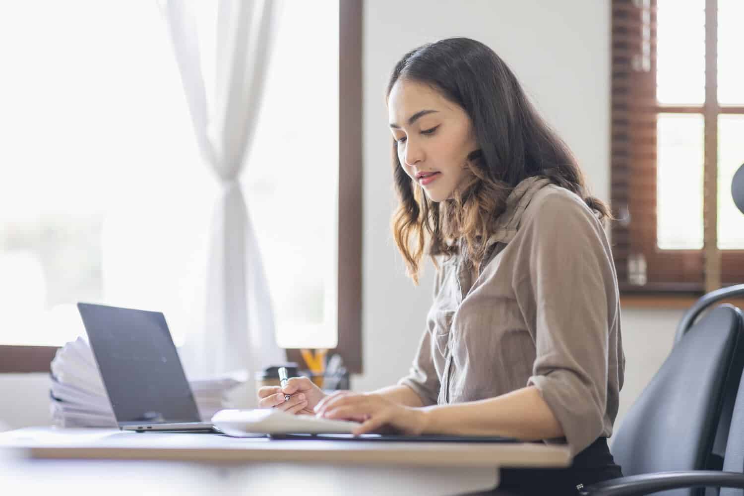 A businesswoman putting together retail business continuity planning for her business.