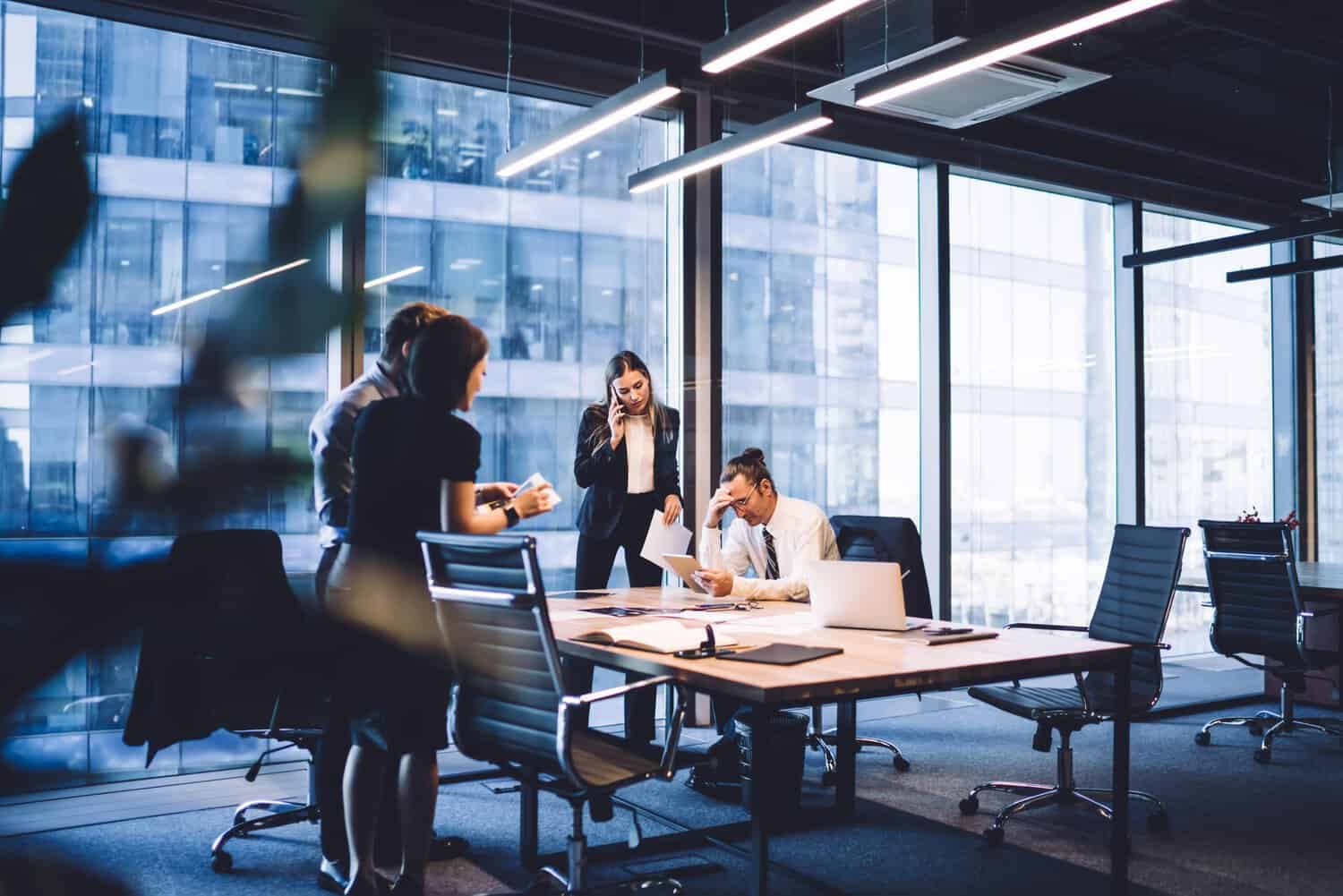 A business team in an office deliberates on business recovery after a cyberattack.