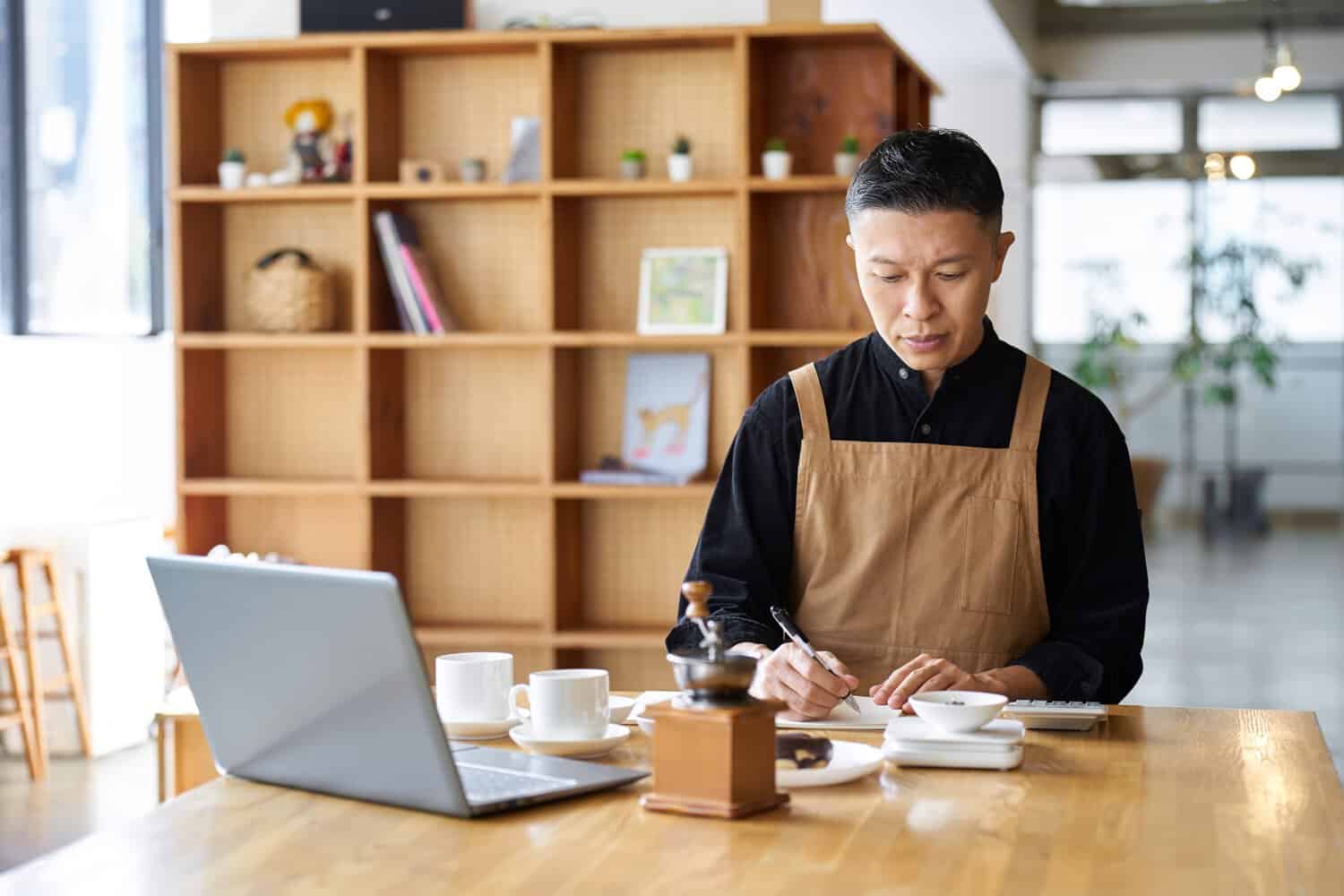 A businessman planning how to adopt cloud transformation services for his F&B brand in Malaysia.