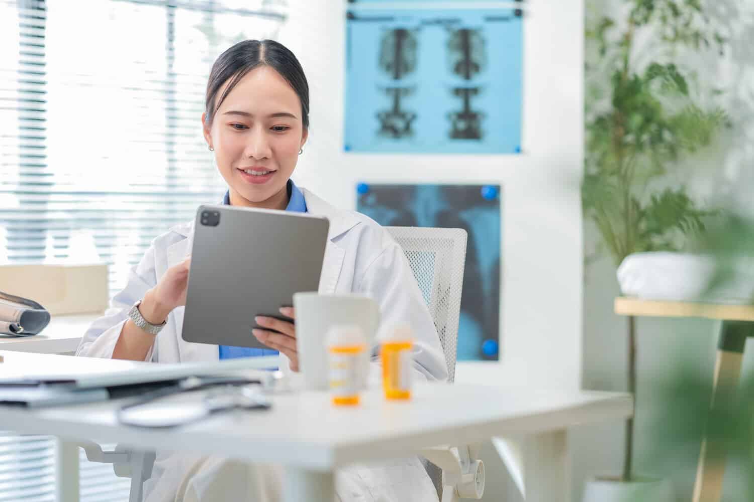 A doctor reviewing new measures for cloud security for healthcare in Malaysia with patient data.
