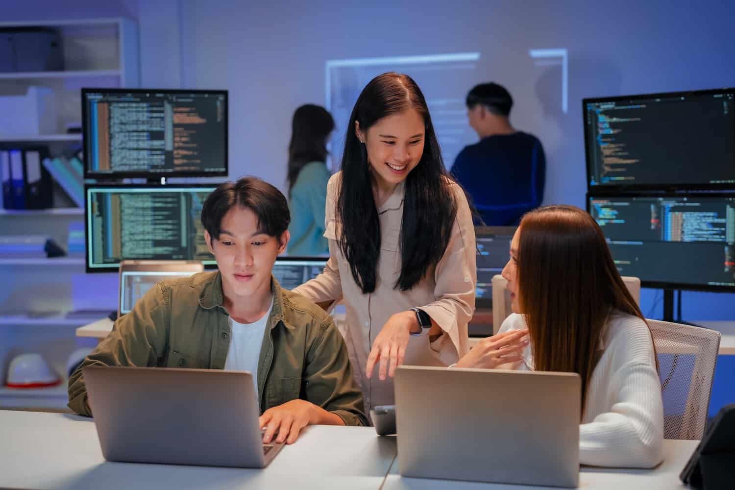 Security operations analysts monitoring a managed SOC dashboard in a cybersecurity control room, tracking live threat alerts across multiple screens