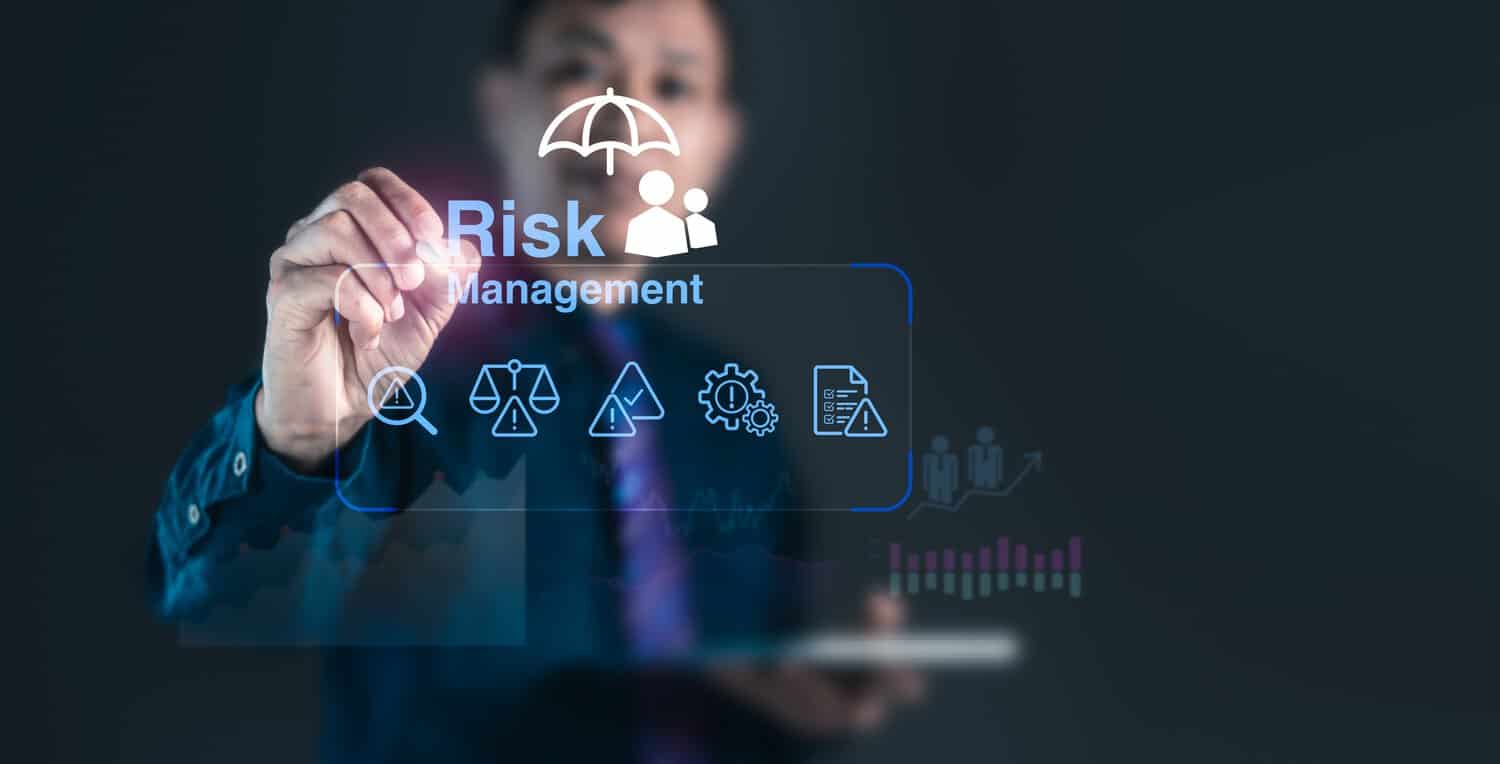 A Malaysian IT manager reviewing a cybersecurity risk assessment report.